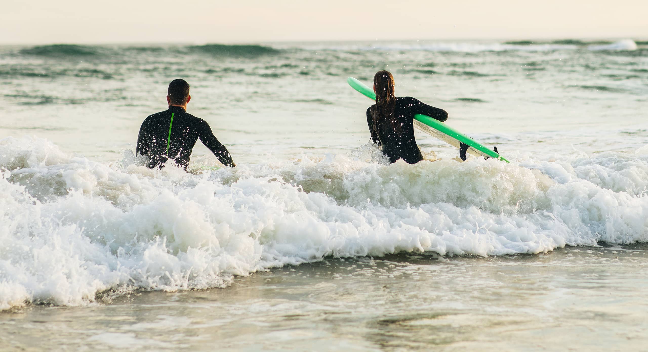 Two surfers preparing to surf